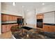 Gourmet kitchen featuring granite counters, a large curved island, custom cabinets, and stainless steel appliances at 2031 Silver St, Pahrump, NV 89048
