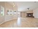 Bright, open living room featuring tile flooring, many windows, and a fireplace with stone surround at 2031 Silver St, Pahrump, NV 89048