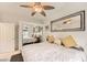 Bright bedroom featuring a ceiling fan and a large framed mirror above the headboard at 2050 W Warm Springs Rd # 3624, Henderson, NV 89014