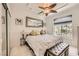 Elegant bedroom featuring a king-size bed, a decorative ceiling fan, and large windows at 2050 W Warm Springs Rd # 3624, Henderson, NV 89014
