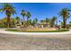 Circular entrance with tiered fountains, lush green space, and an abundance of palm trees at 2050 W Warm Springs Rd # 3624, Henderson, NV 89014