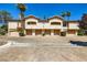Attractive townhome exterior with garages, landscaped grounds and mature trees under a clear blue sky at 2050 W Warm Springs Rd # 3624, Henderson, NV 89014