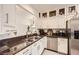 Bright kitchen featuring a stainless steel dishwasher, granite countertops, and ample cabinetry at 2050 W Warm Springs Rd # 3624, Henderson, NV 89014