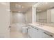 Well-lit bathroom with a soaking tub, marble countertops, and tiled floors at 222 Karen Ave # 2305, Las Vegas, NV 89109