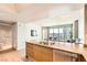 Kitchen with granite countertops and stainless appliances overlooks city views from the adjacent living area at 222 Karen Ave # 2305, Las Vegas, NV 89109
