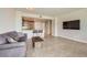 Open living room featuring a modern kitchen, tile floors, comfortable seating, and a large screen TV at 222 Karen Ave # 2305, Las Vegas, NV 89109