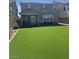 The backyard is enhanced with artificial turf, providing a lush, low-maintenance outdoor space at 2645 Cava Tirreni St, Henderson, NV 89044