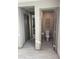 Hallway view of a compact bathroom with tile flooring and neutral wall decor and open doorway at 2645 Cava Tirreni St, Henderson, NV 89044