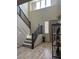 Bright entryway features tall ceilings, staircase with wood railing, and wood-look floors at 2645 Cava Tirreni St, Henderson, NV 89044