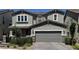 Two-story home with a gray exterior, a two-car garage, and manicured landscaping at 2645 Cava Tirreni St, Henderson, NV 89044