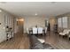 Open-concept living and dining area features modern decor and wood-look floors at 2645 Cava Tirreni St, Henderson, NV 89044