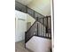 View of staircase with dark wood railing and decorative wall paneling at 2645 Cava Tirreni St, Henderson, NV 89044