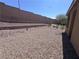 Backyard featuring gravel and tiered planting beds and a block wall at 2653 Crystal Blue St, Laughlin, NV 89029