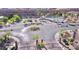 Aerial view of the gated community with a pool, roundabout, and palm trees at 2653 Crystal Blue St, Laughlin, NV 89029