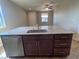 Kitchen island featuring granite countertops, a stainless steel sink, and a dishwasher at 2653 Crystal Blue St, Laughlin, NV 89029