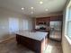Modern kitchen with granite countertops, stainless steel appliances, and an island sink at 2653 Crystal Blue St, Laughlin, NV 89029