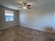 Bright living room featuring neutral walls, tile floors, and a ceiling fan at 2653 Crystal Blue St, Laughlin, NV 89029