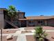 Exterior view of a well-maintained single-story building with a desert landscape and stairway at 2657 Kline Cir, Las Vegas, NV 89121