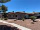 Exterior view of a well-kept single-story home with desert landscaping and a walkway at 2657 Kline Cir, Las Vegas, NV 89121