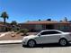 View of a well-maintained single-story home with a desert landscape and a car in the driveway at 2657 Kline Cir, Las Vegas, NV 89121