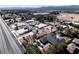 Elevated aerial captures property showcasing surrounding desert, landscaped yards, and a distant mountain view at 2755 E Russell Rd, Las Vegas, NV 89120