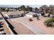 Aerial view of a property featuring a spacious driveway, manicured desert landscaping, and palm trees at 2755 E Russell Rd, Las Vegas, NV 89120