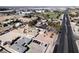 Property aerial with neighboring businesses, a residential home, and ample space at 2755 E Russell Rd, Las Vegas, NV 89120