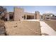 Backyard view featuring a concrete patio, walkway, and a combination of dry and dirt landscaping at 2755 E Russell Rd, Las Vegas, NV 89120