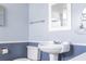 Traditional bathroom featuring a pedestal sink, mirror, and toilet at 2755 E Russell Rd, Las Vegas, NV 89120