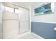 Bathroom with tiled walk-in shower and modern waterfall art at 2755 E Russell Rd, Las Vegas, NV 89120
