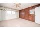 Bedroom with a paneled accent wall, ceiling fan, and a window with light drapes at 2755 E Russell Rd, Las Vegas, NV 89120