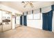 Spacious bedroom with mirrored closet doors, blue curtains, and plush carpeting, with a ceiling fan at 2755 E Russell Rd, Las Vegas, NV 89120