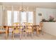 Classic dining area featuring a decorative chandelier and bright natural light from large window at 2755 E Russell Rd, Las Vegas, NV 89120