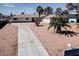 Inviting single-story residence with a long driveway, palm trees, and a well-maintained desert landscape at 2755 E Russell Rd, Las Vegas, NV 89120