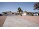 Charming single-story home with an expansive driveway and a well-manicured desert landscape at 2755 E Russell Rd, Las Vegas, NV 89120