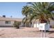 Home's front exterior showcasing a well-maintained yard with desert landscaping and palm trees at 2755 E Russell Rd, Las Vegas, NV 89120