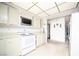 Traditional kitchen featuring cream-colored cabinets and white appliances at 2755 E Russell Rd, Las Vegas, NV 89120