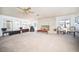 Spacious living room with a stone fireplace, ample seating, and abundant natural light at 2755 E Russell Rd, Las Vegas, NV 89120