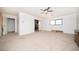A large main bedroom featuring a ceiling fan, a view of the closet, and natural light from a large window at 2755 E Russell Rd, Las Vegas, NV 89120
