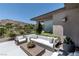 Comfortable back patio sitting area offers serene views of the community landscaping and water feature at 2797 Turtle Head Peak Dr, Las Vegas, NV 89135