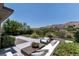 Relaxing backyard with comfortable seating, drought resistant landscaping, and a beautiful water view at 2797 Turtle Head Peak Dr, Las Vegas, NV 89135