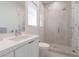 Sleek bathroom featuring a glass-enclosed shower, white vanity, toilet, and modern fixtures at 2797 Turtle Head Peak Dr, Las Vegas, NV 89135