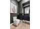 Stylish powder room with dark walls, a floating vanity, and chic décor, showcasing a modern design at 2797 Turtle Head Peak Dr, Las Vegas, NV 89135