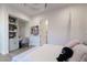 Bright bedroom featuring a built-in desk, and ample natural light from the adjacent bathroom at 2797 Turtle Head Peak Dr, Las Vegas, NV 89135