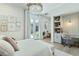Bright bedroom with a built-in desk area, French doors, and stylish decor at 2797 Turtle Head Peak Dr, Las Vegas, NV 89135