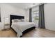 Comfortable bedroom featuring a plush bed, hardwood floors, and calming décor, ideal for relaxation at 2797 Turtle Head Peak Dr, Las Vegas, NV 89135