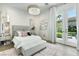 Bright and airy bedroom with a cozy bed, stylish décor, and access to the outdoor space at 2797 Turtle Head Peak Dr, Las Vegas, NV 89135