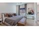 Cozy bedroom featuring a comfortable bed, a window with curtains, and a built-in desk area at 2797 Turtle Head Peak Dr, Las Vegas, NV 89135