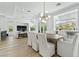 Dining area featuring modern chandelier, a large wood table, and views of the exterior mountain scenery at 2797 Turtle Head Peak Dr, Las Vegas, NV 89135