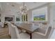 Elegant dining room with a large table, stylish chairs, and views of the landscape at 2797 Turtle Head Peak Dr, Las Vegas, NV 89135